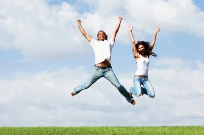 Two people jump in the air.