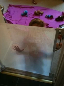 A person is drying off with a towel inside a room.