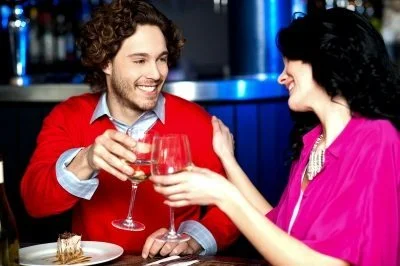 Two people hold wine glasses.