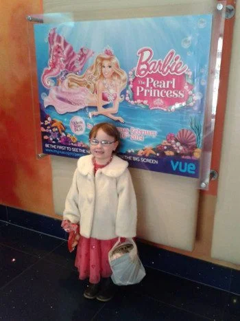 A person stands in front of a poster.