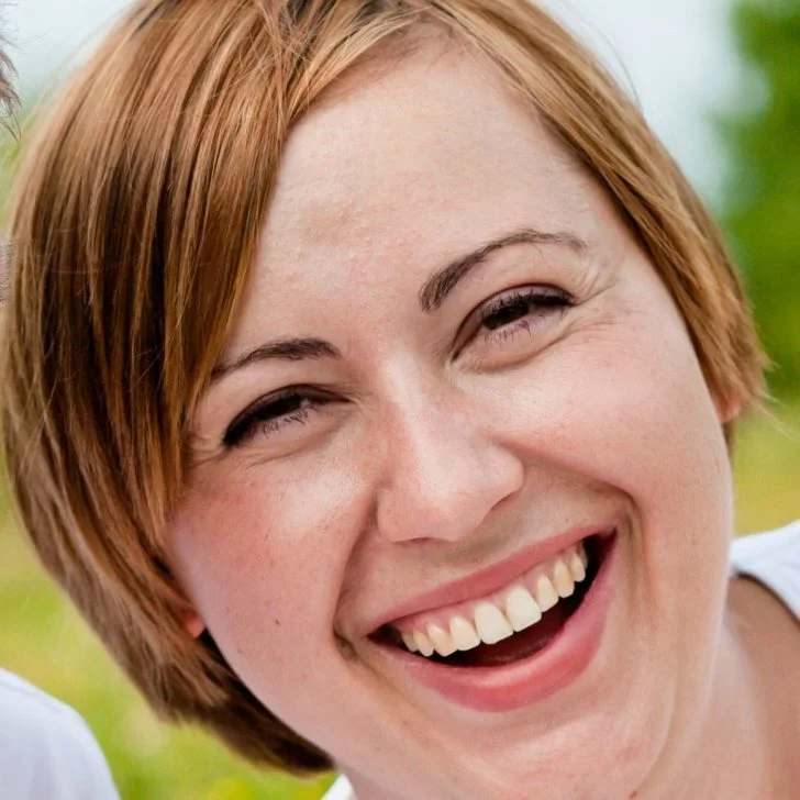 A close-up of someone is smiling.