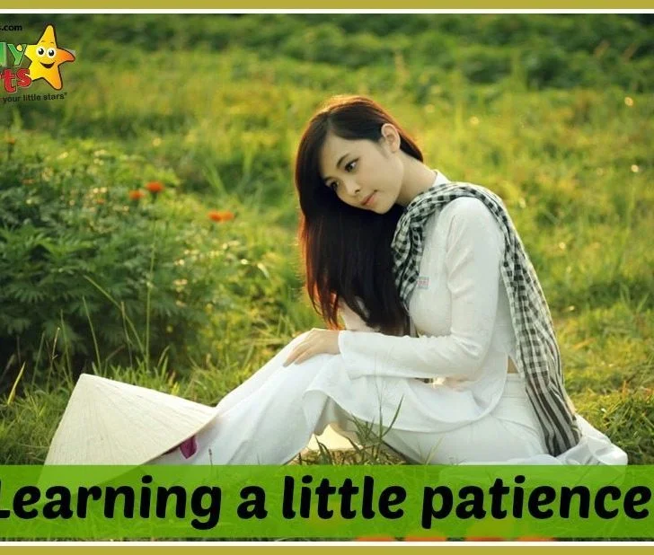 A person sits in a grassy area.