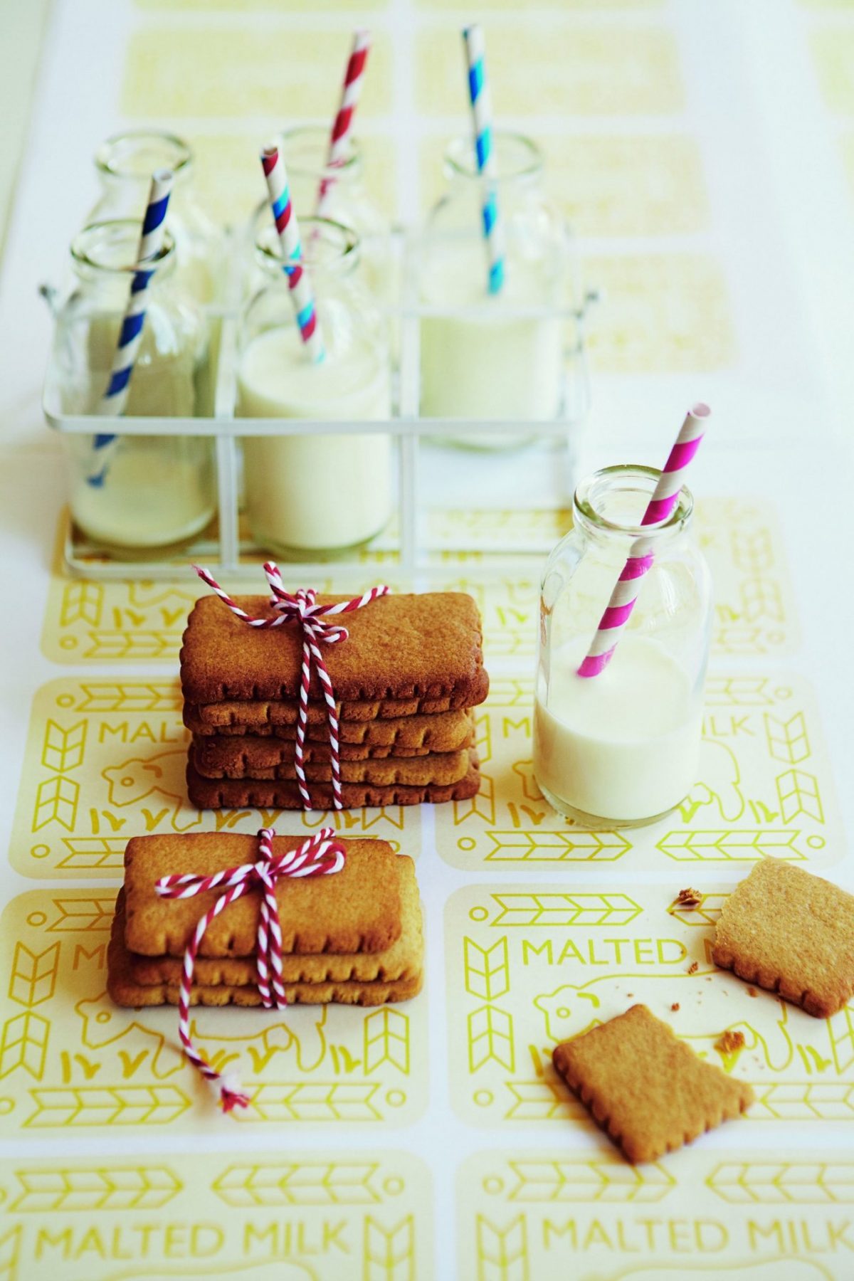 A candle flickers on a table filled with freshly-baked desserts and snacks.