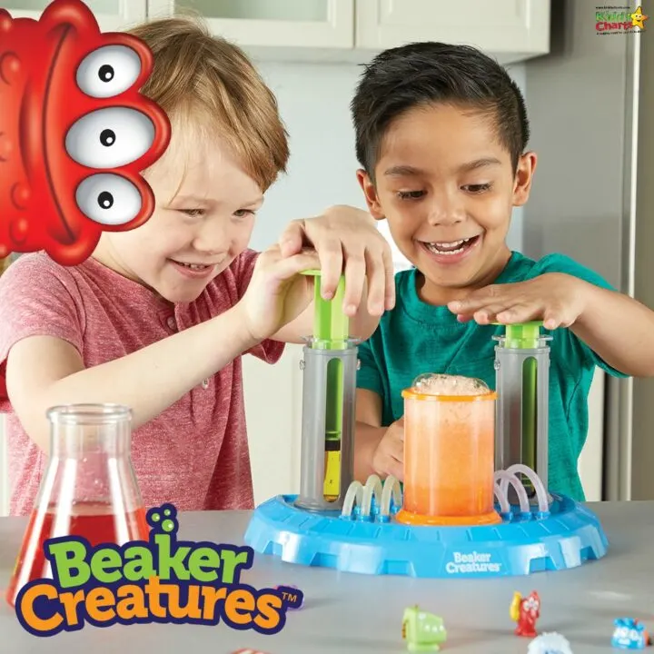 A smiling toddler is celebrating their birthday indoors while enjoying a Beaker Creatures® soft drink and juice.