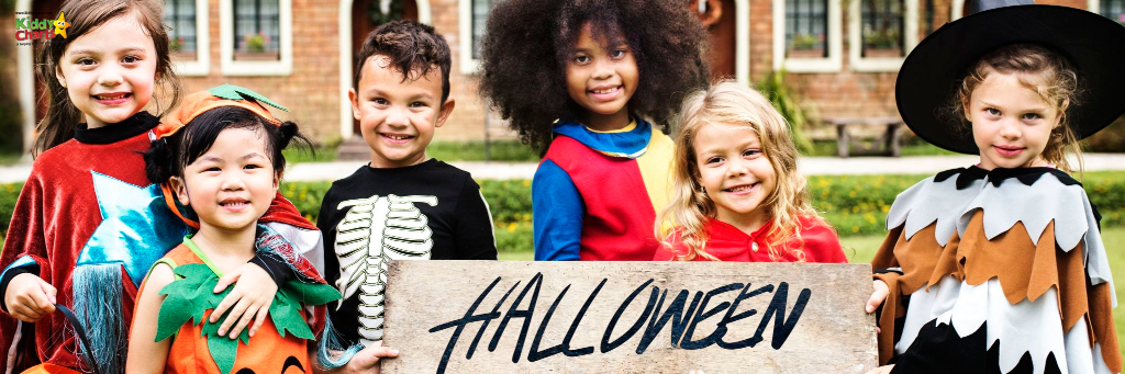 Trick or treating: children holding Halloween banner.