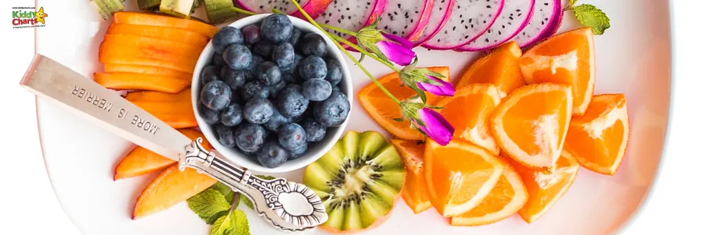 A plate of fruit and a silver spoon.