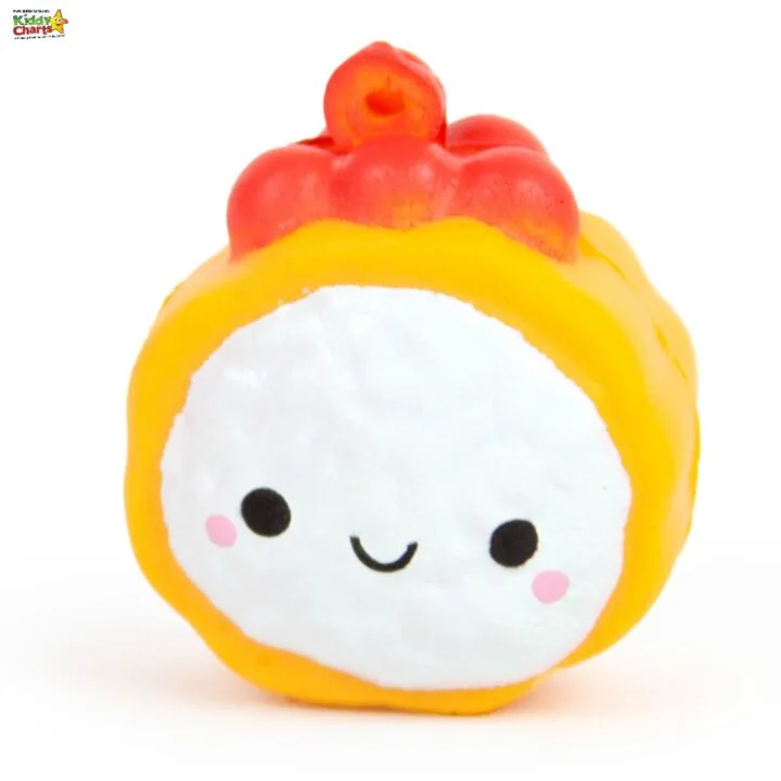 A smiling cartoon emoticon plush toy sits amongst a variety of baby toys.