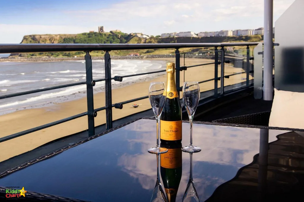 Bottle of champagne on balcony overlooking the beach.