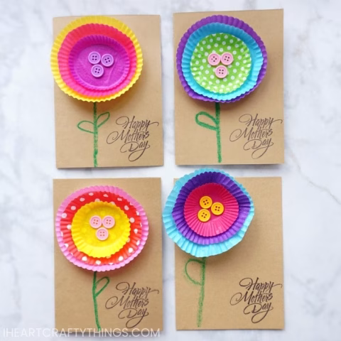 A child is proudly displaying their handmade craft to celebrate Mother's Day.