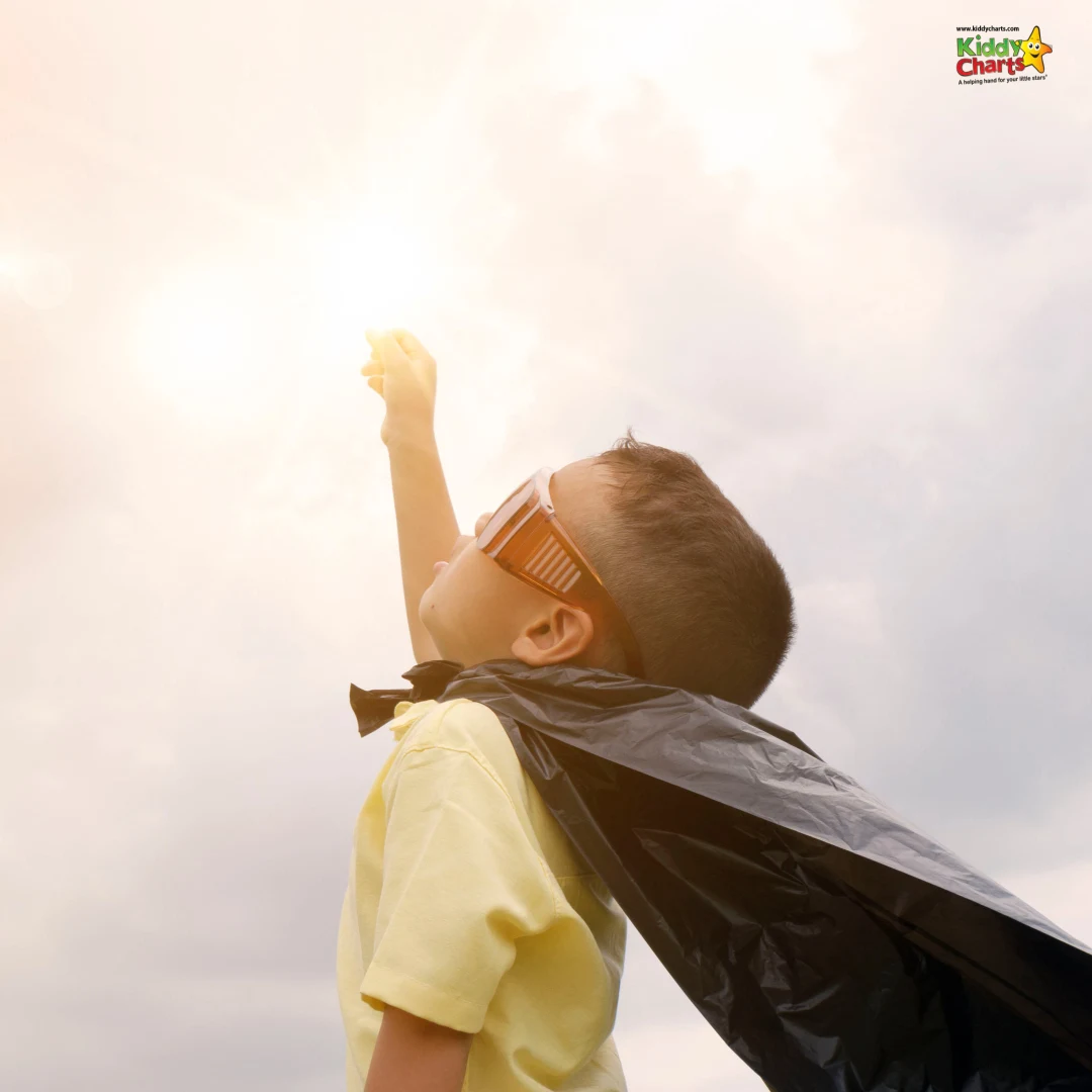 Boy in superhero pose and costume looking up at sky: get active together.