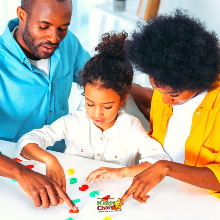 A toddler is learning and sharing with an adult indoors.