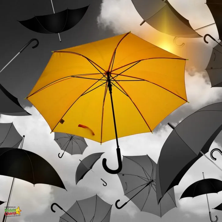 A person holds an umbrella while studying colorful charts.
