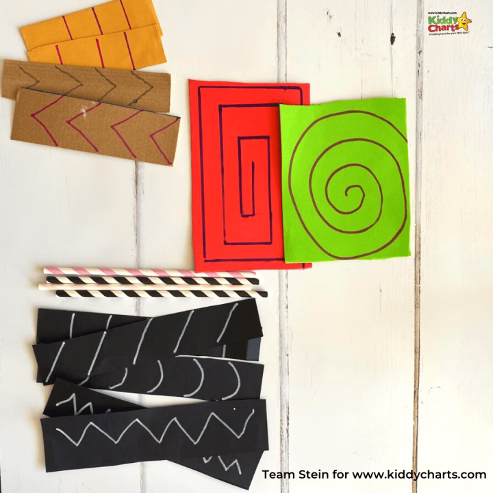A child is handwriting text on a post-it note affixed to a rectangle of colorful child art.