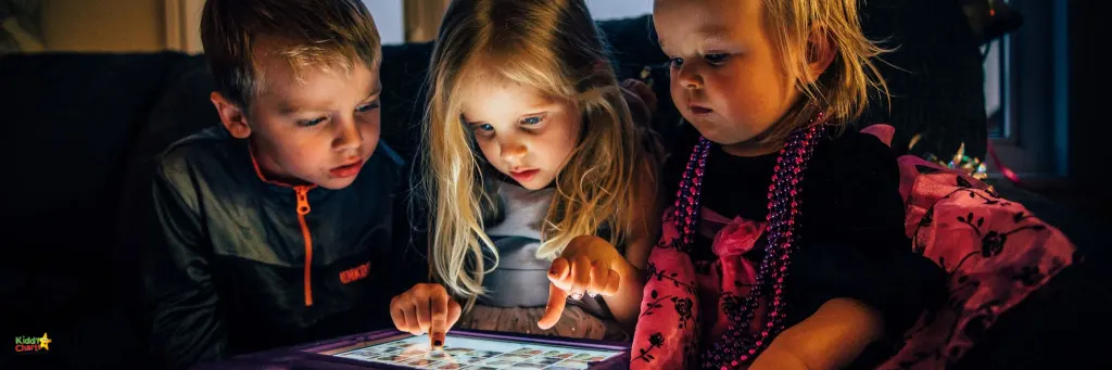 3 children playing with a tablet