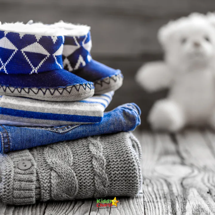 A stack of blue cloth textiles sits indoors, ready to be used for Kiddy Charts projects.