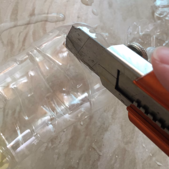 A plastic tool is being used indoors.