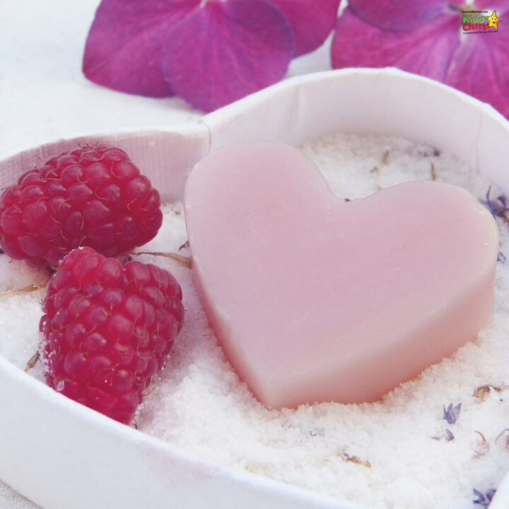 A pink raspberry berry sits atop a flower-patterned plate, adding a touch of sweetness to the indoor food display.