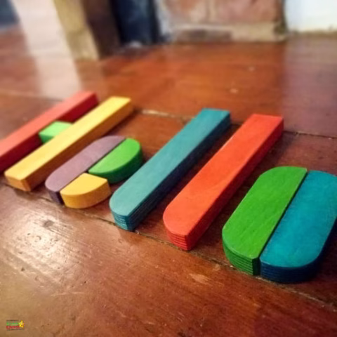 A lined wooden writing implement lies on the indoor surface.