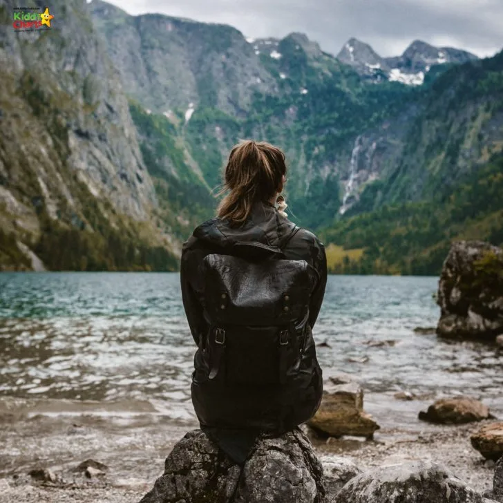 They observe a body of water from a rock.
