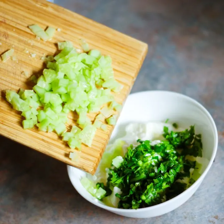 A wooden table is filled with a variety of vegetarian food, including broccoli and other cruciferous vegetables, making it an ideal ingredient for any indoor cuisine.