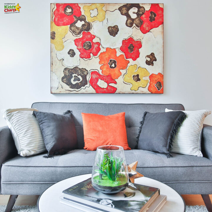 A couch with a coffee table and a wall with art on it.
