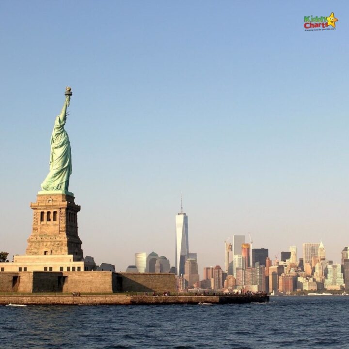 A statue of liberty with a city in the background.