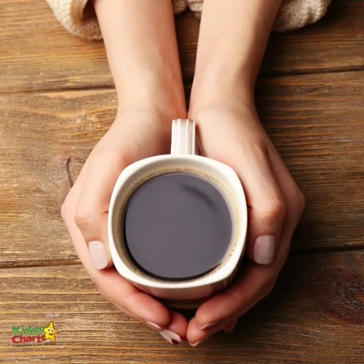 A person holds a cup.