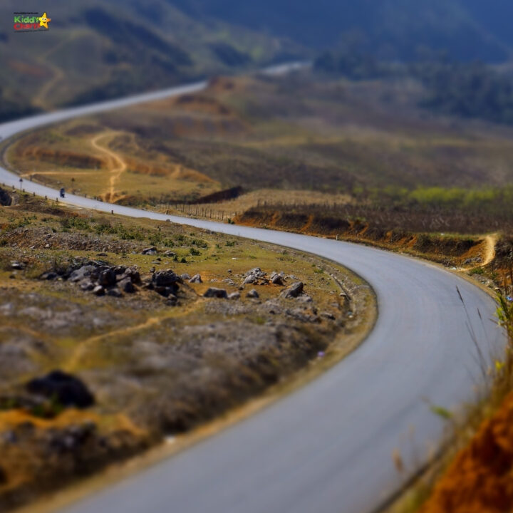 Aerial photography captures the stunning nature of the outdoor road, landscape, mountain, grass, and river.