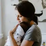 A person holds a baby.