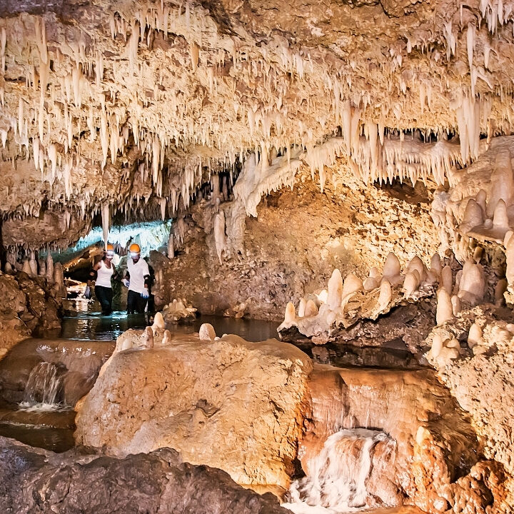 People stand in a cave.