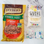 This image is advertising Snyder's of Hanover family-sized pretzels, candy melts, candy eyeballs, and Great Value products.