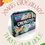 The image is promoting a Christmas giveaway of an educational Chemistry Lab set with 80+ experiments, 10 chemicals, and a manual to help learn STEM.