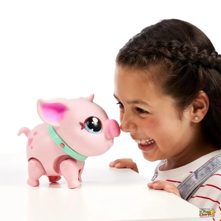 A smiling person holds a toy piggy bank in front of their face, surrounded by a person and animal figures.