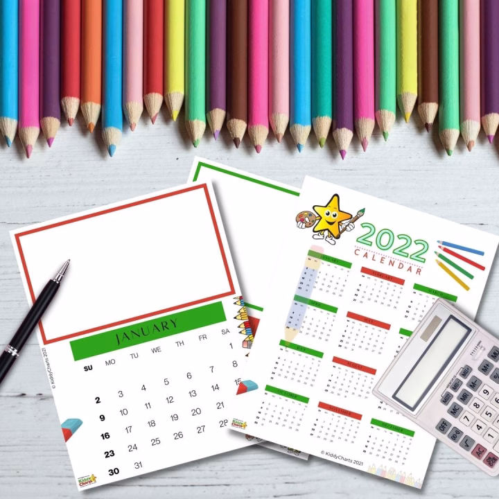A pencil and pen mark the 2022 calendar on a sheet of stationery surrounded by office supplies.