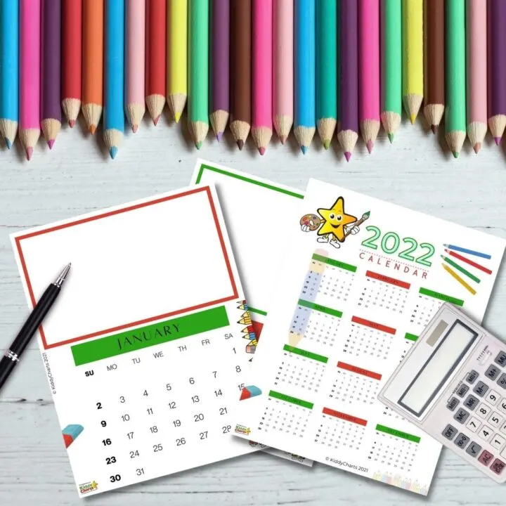 A pencil and pen mark the 2022 calendar on a sheet of stationery surrounded by office supplies.
