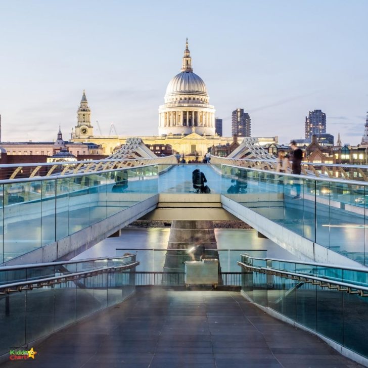 A city skyline with a landmark building, a pool, a bridge, and a body of water stretches out beneath a bright blue sky, beckoning travelers to explore.