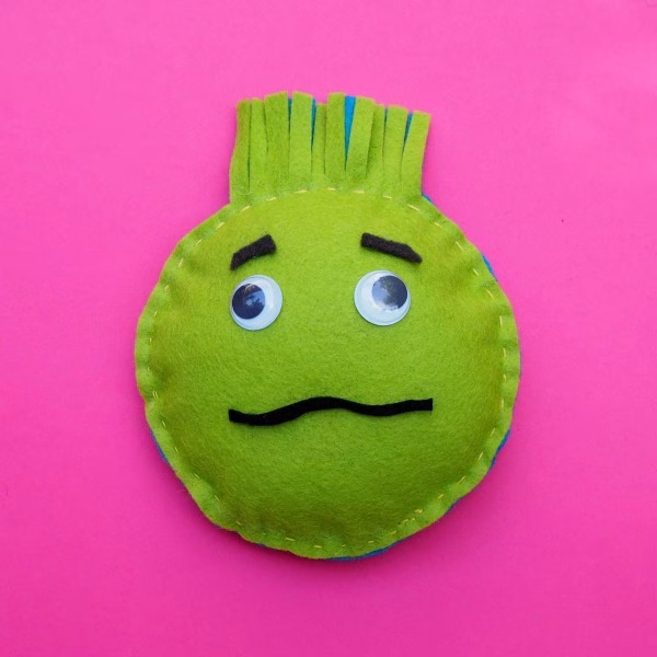 A cartoon smiley emoticon toy is smiling brightly.