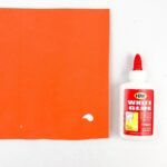 This image is advertising a 100gms tube of white glue that can be used to quickly glue paper, wood, leather, cloth, and other materials.