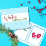 The image is of a set of winter-themed spelling cards from KiddyCharts for the year 2023.