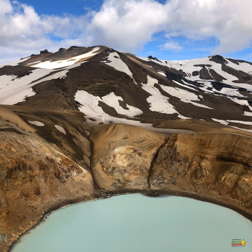 A glacial lake surrounded by a mountain range and snow-covered ridge creates a stunning landscape of nature in the sky above a glacial landform and depression of a crater lake.