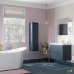 A modern bathroom with a luxurious bathtub, sink, tap, window, shower, tile, cabinetry, mirror, tub, and ceiling is being renovated to create a stylish interior design for a property.