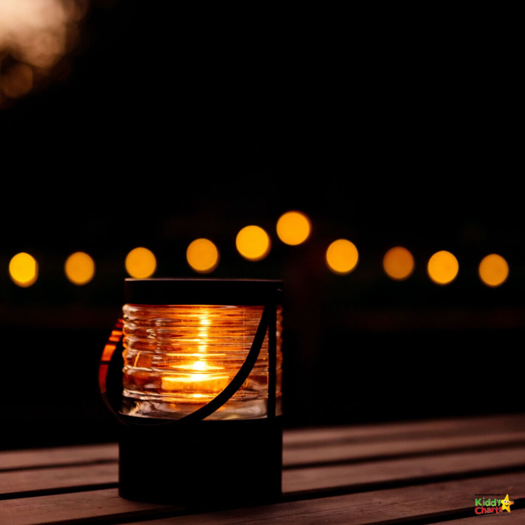 The flickering amber flame of the lantern lights up the night outdoors.