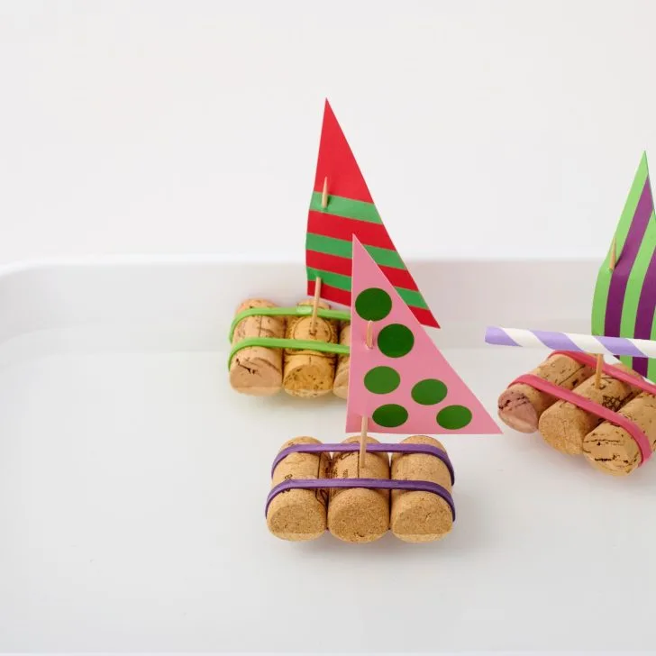 A colorful array of finger food desserts and snacks are displayed on a table indoors.