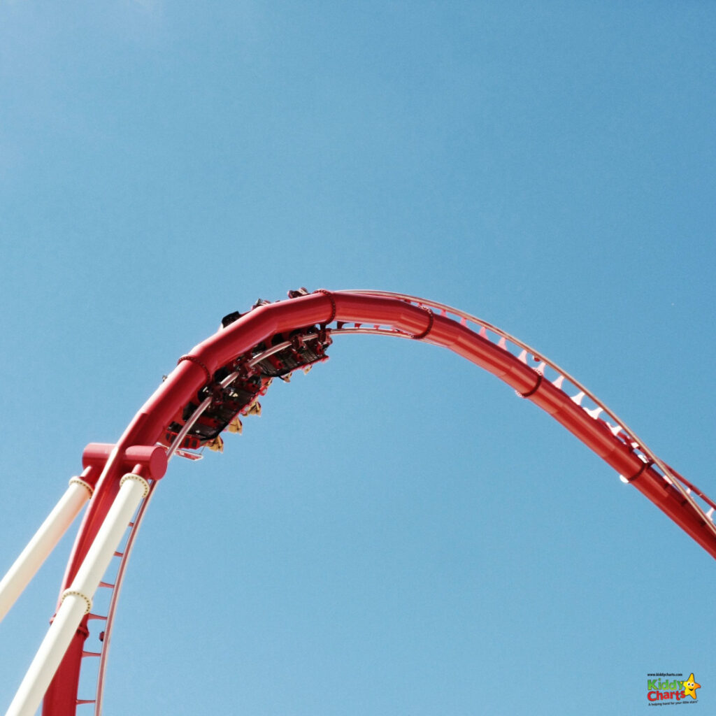 The red roller coaster whizzes around the track.