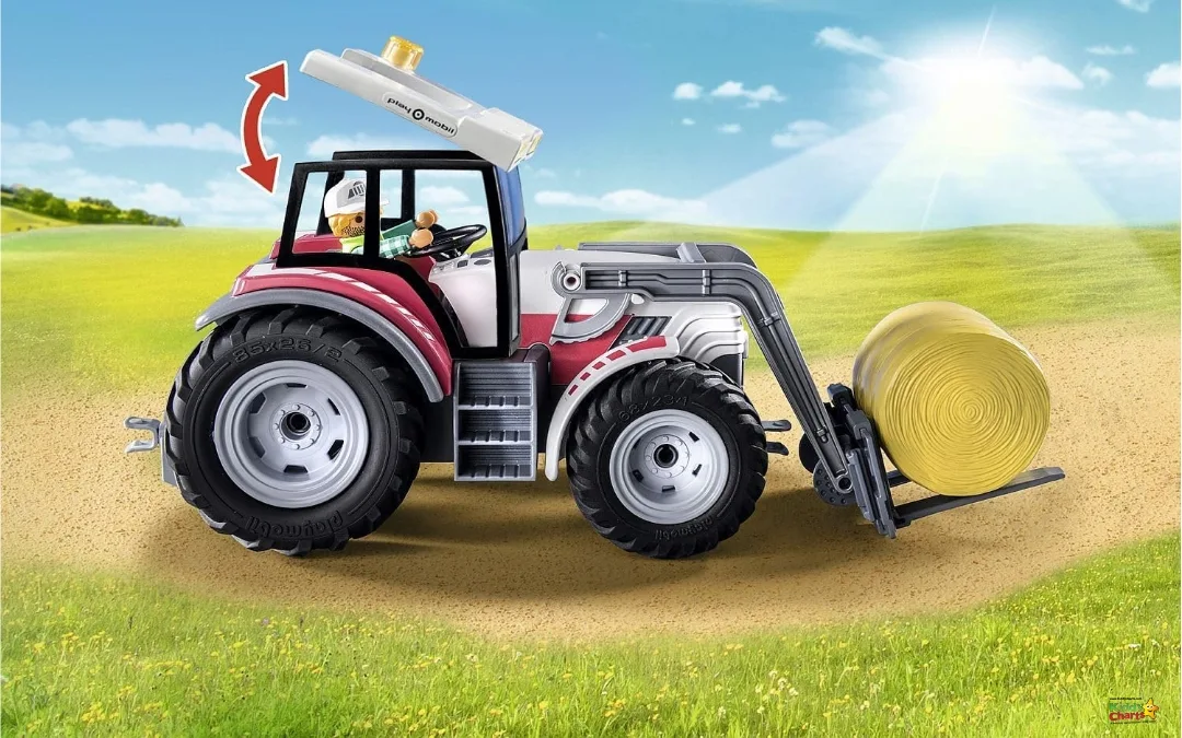 A tractor is driving across a field, its off-road tires leaving tread marks in the grass beneath the bright blue sky.