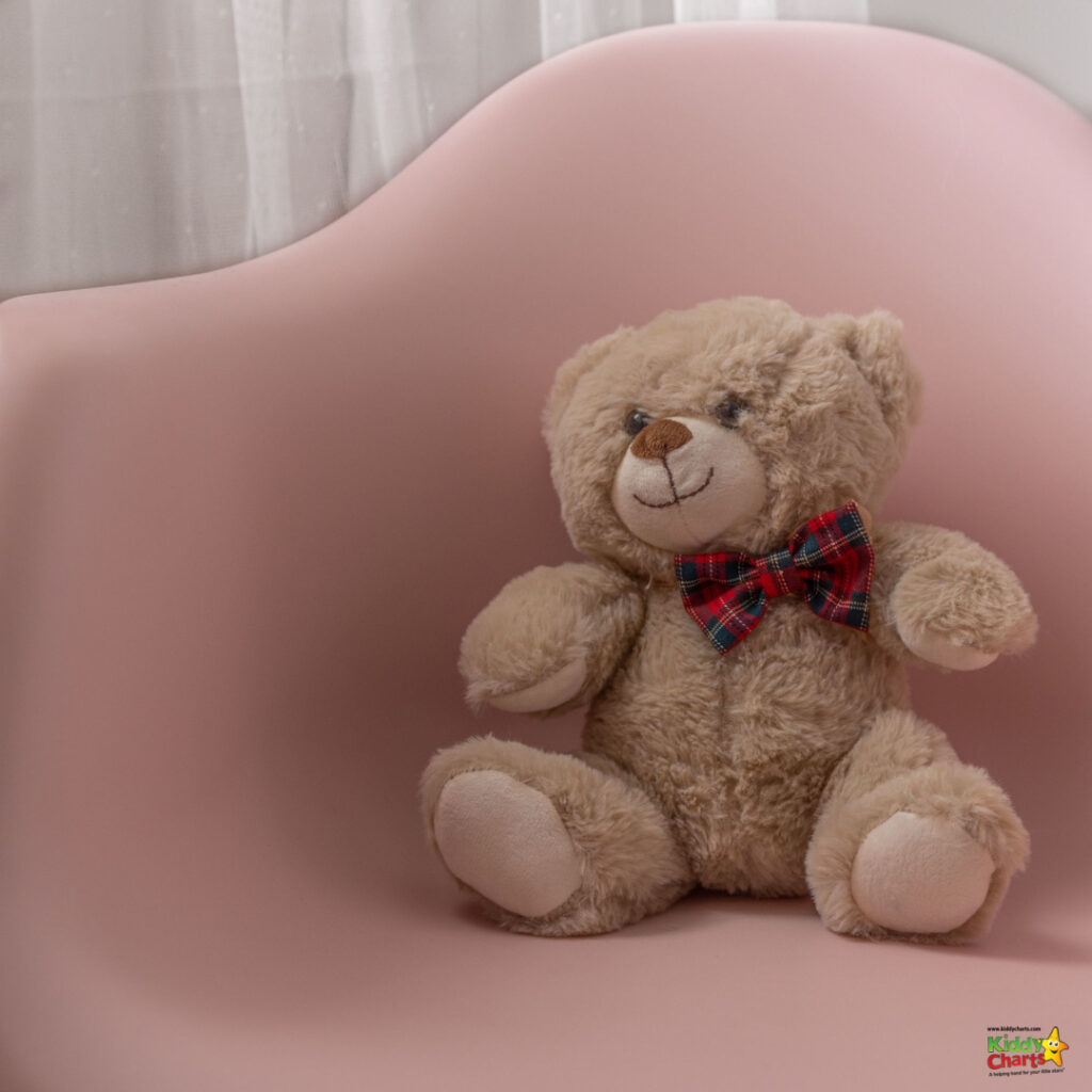 The teddy bear sits on the pink chair.
