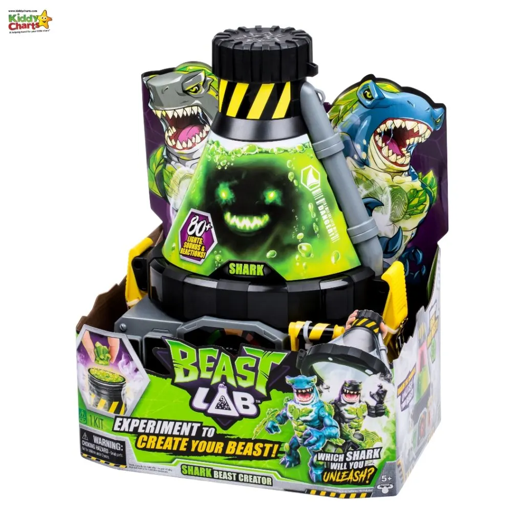 This image shows a toy called "Beast Lab Shark Beast Creator," featuring shark illustrations, a bubbly green chemical reaction, and the tagline "Experiment to Create Your Beast!"