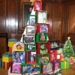 A decorated Christmas tree stands in the middle of an indoor room, filled with the best Christmas gifts for kids in 2023.