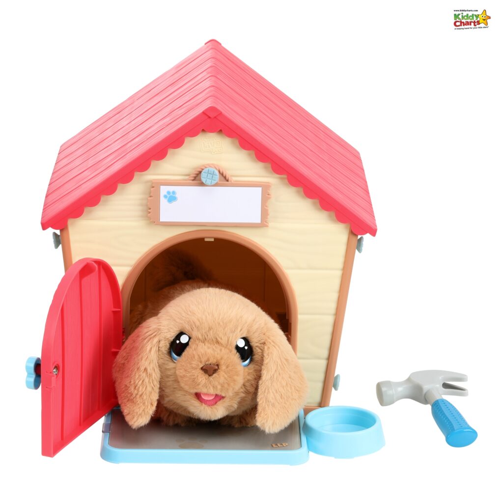 A plush toy dog is peeking out of a colorful toy doghouse with a red roof and open red door, accompanied by a blue bowl and a toy hammer.
