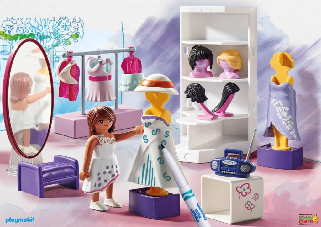 This image displays a Playmobil toy set featuring a clothing boutique scene with a figure, dresses, wigs, a mirror, and accessories like a radio.